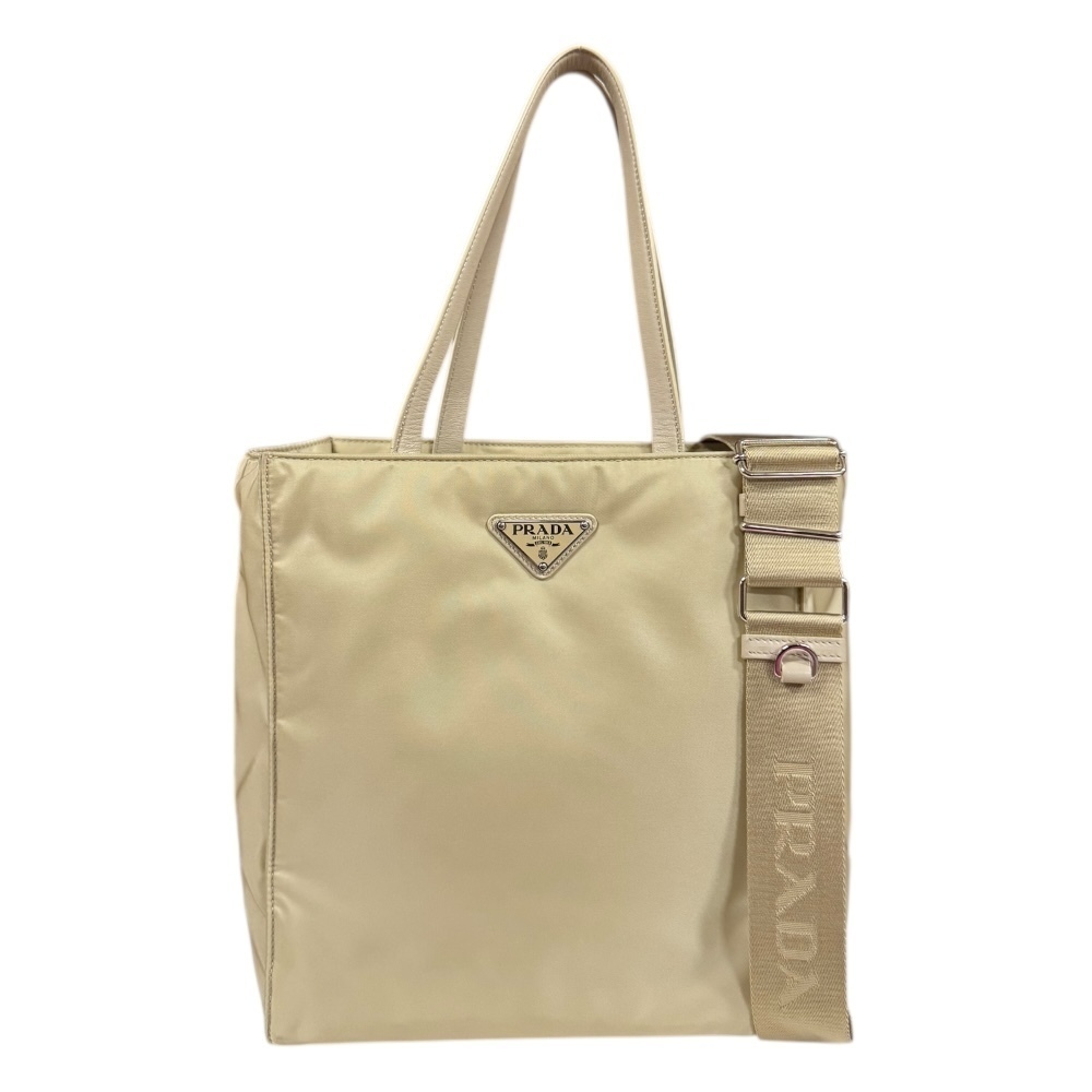 Prada beige tote bag prominent front triangle logo shoulder strap Tan
